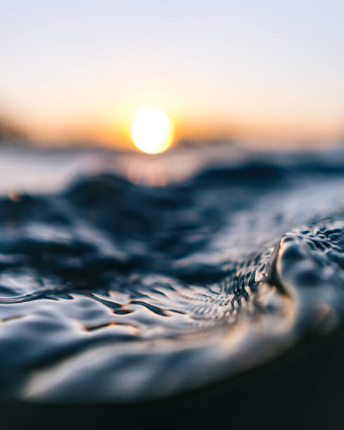 istock Macro shot of water surface in orange sunset 2156772565