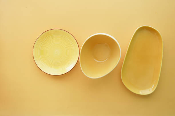 top view of different shape yellow color bowl or ceramic plates