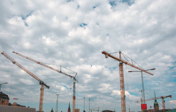 Construction cranes on the site of a hospital expansion site.