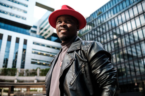 istock Smiling black male model posing surrounded by modern buildings. 2156782044