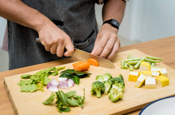 istock Chef at the kitchen preparing green curry with herbs and rice 2156782349