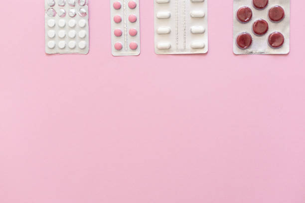 istock pills in blisters are white and pink on a pink background 2156782910