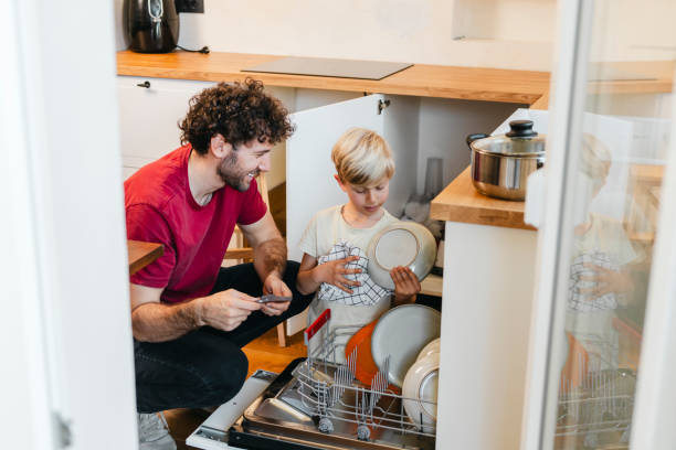 istock Son helping father with the dishwasher 2156783013