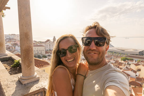 istock Happy couple taking selfie while traveling in Lisbon 2156783117