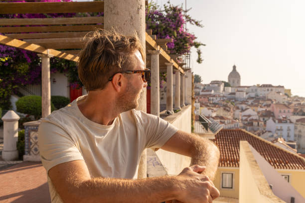 istock Man on Traditional Terrace Overlooking Lisbon's Alfama District 2156783145