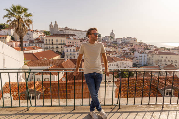 istock Man Relaxing on a Balcony Overlooking the Lisbon Cityscape 2156783318