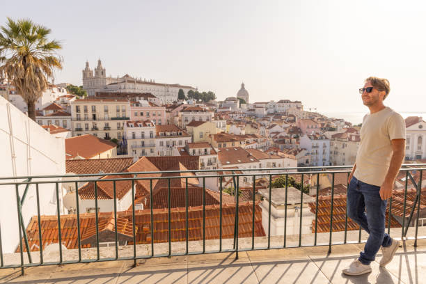istock Man Admiring Historic Cityscape, he walks on a terrace 2156783425