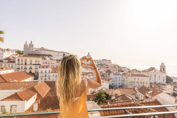 istock Woman Making Heart Shape with Hands Over Cityscape 2156783487