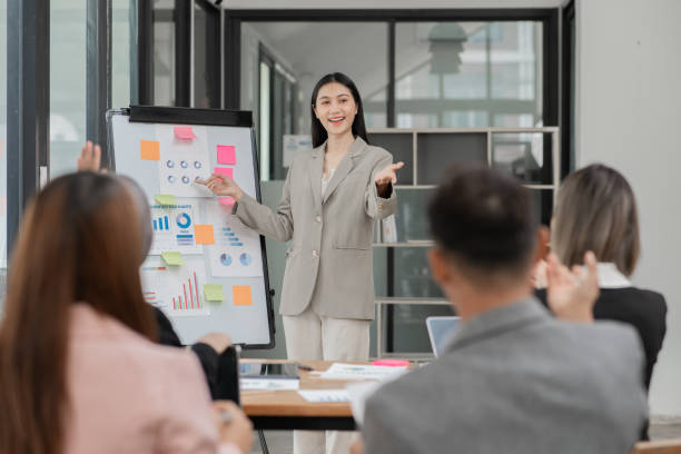 istock Group of Asian businessmen are presenting graphs on a whiteboard. 2156783841