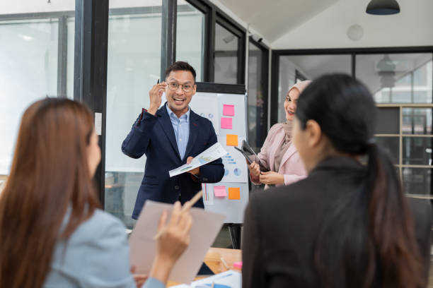 istock Group of Asian businessmen are presenting graphs on a whiteboard. 2156783853