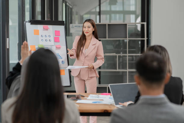 istock Group of Asian businessmen are presenting graphs on a whiteboard. 2156783856
