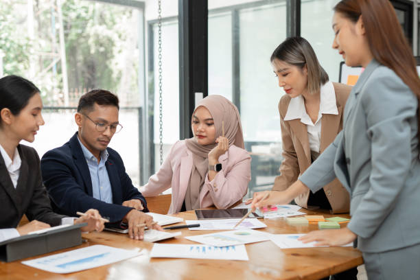 istock Asian business group discussing graph work at the office 2156783862