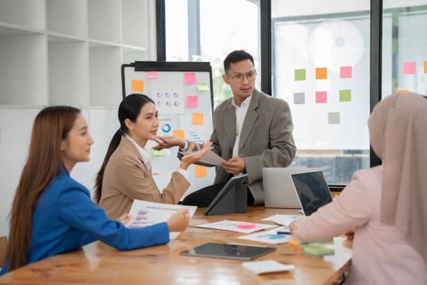 istock Asian business group discussing graph work at the office 2156783871