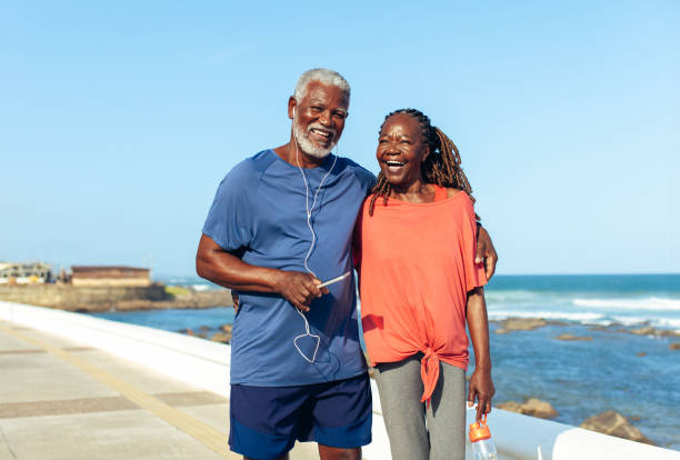 istock Older couple enjoying a sunny seaside walk together 2156788331