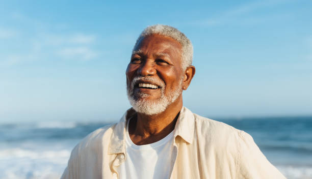 istock Blissful elderly man smiling by the ocean 2156788665