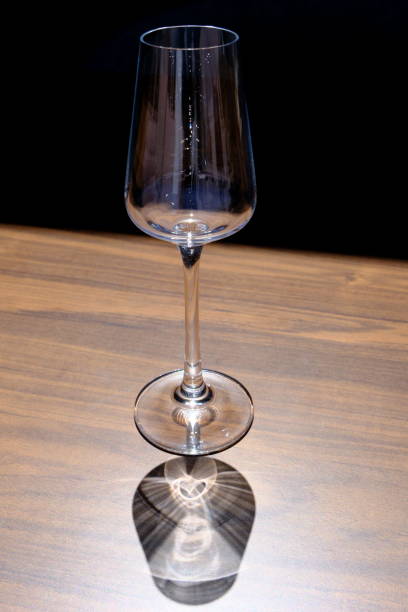 istock empty glass and its shadow on a wooden table 2156790043