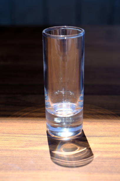 istock empty glass and its shadow on a wooden table 2156790143
