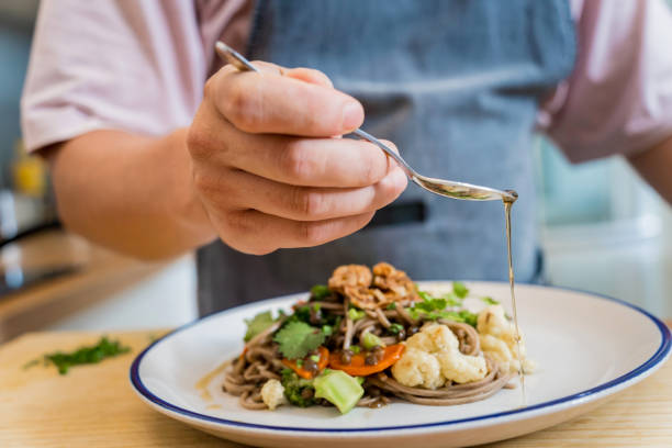 istock Chef at the kitchen preparing japanese buckwheat pasta with lentils 2156797117