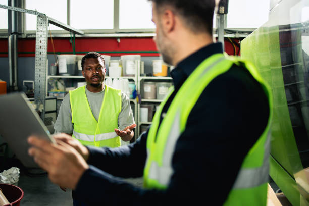 istock Two staff members from the factory running the machines, using tablet 2156799932