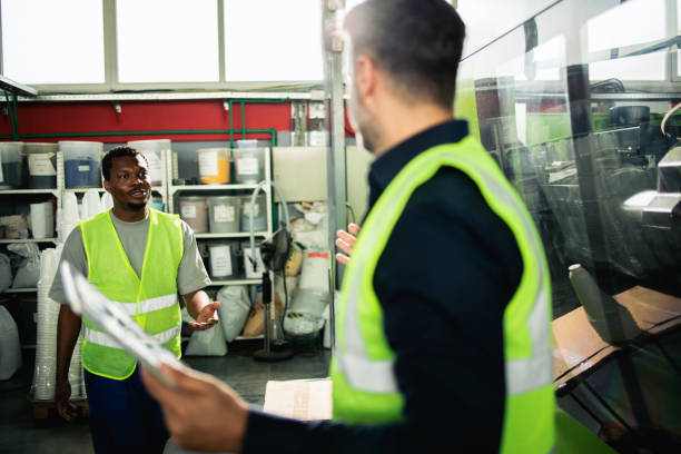 Two operators from the factory handling the equipment