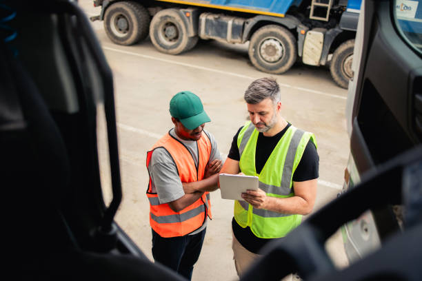 Two truck drivers planning the transportation