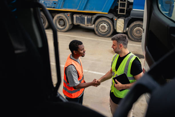 istock Two warehouse truck drivers shaking hands after the handover 2156800027