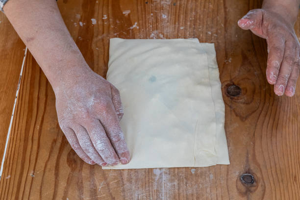 istock A woman prepares traditional Turkish pancake dough for baking. 2156800069