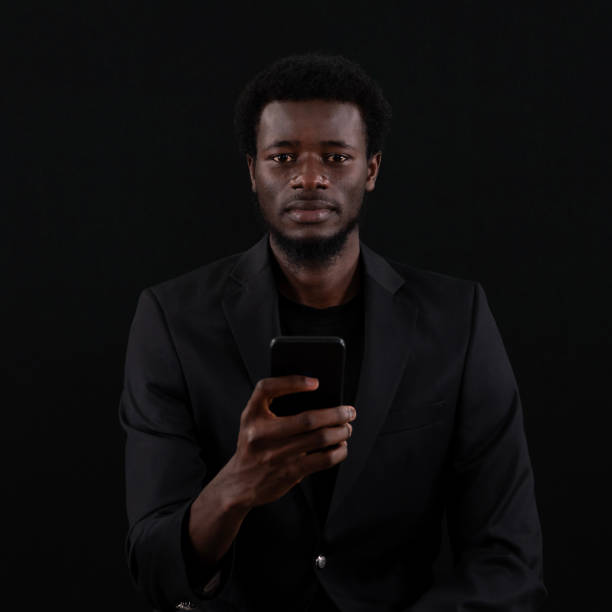 istock Businessman Holding smart phone, And Pointing With One Finger On Important Message. Executive In Suit Presenting Crucial Information. 2156800920