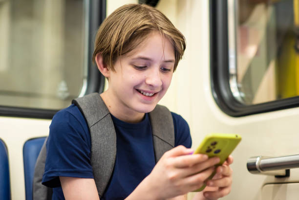 istock boy with smartphone in the subway 2156801801