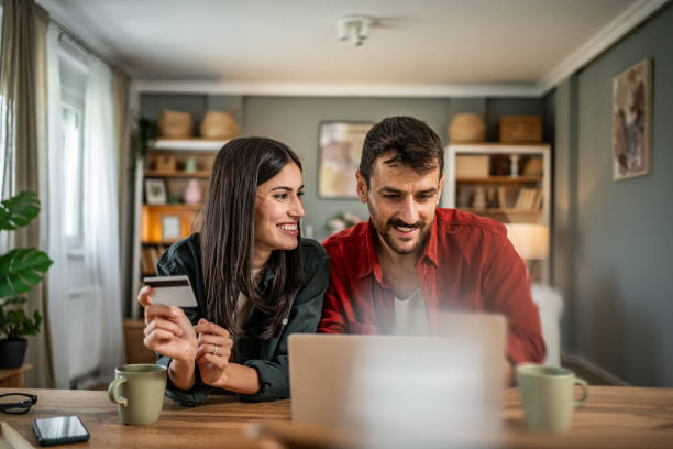 istock Young couple in love using laptop for online shopping 2156803277