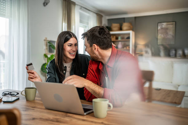 istock Young couple in love using laptop for online shopping 2156803299