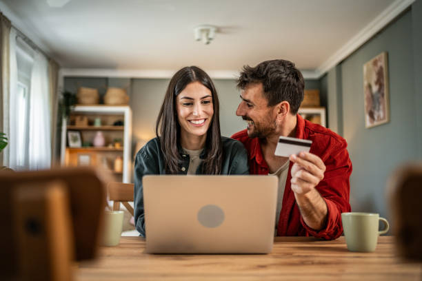 istock Young couple in love using laptop for online shopping 2156804143