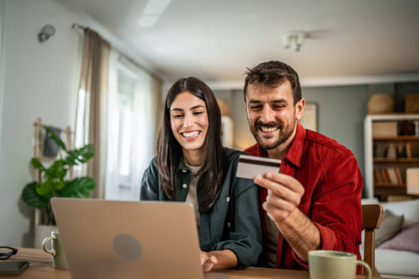 istock Young couple in love using laptop for online shopping 2156804225