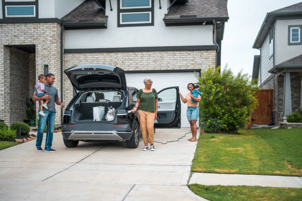 istock Diverse Family with Electric Vehicle at Solar-Powered Home 2156804485