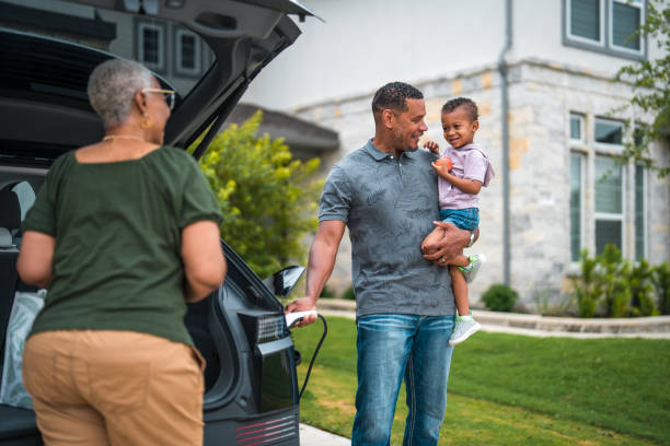 istock Electric Car Charging Family Moment 2156804505