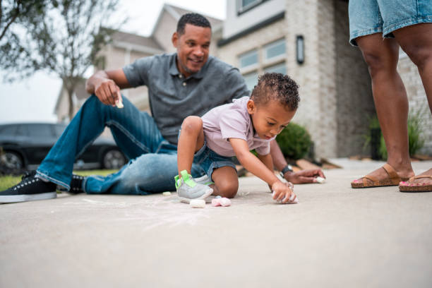 istock Diverse Father and Son Chalk Art Adventure Outside Home 2156804570