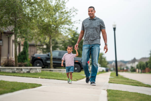 istock Diverse Father and Son Duo Enjoy a Leisurely Stroll 2156804591