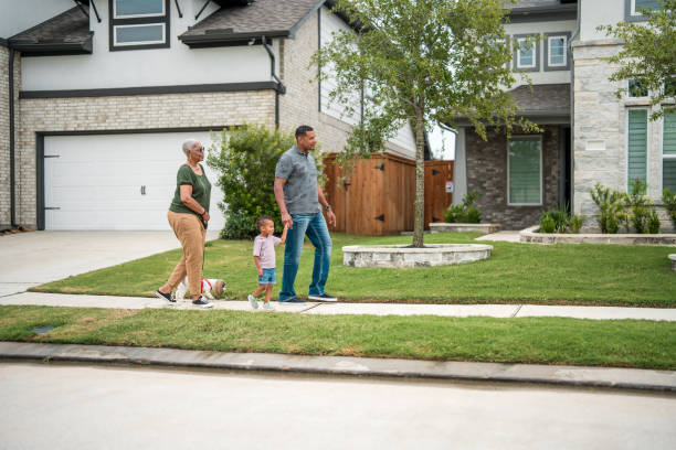 istock Diverse Family Enjoying a Walk by Eco-Friendly Home 2156804594