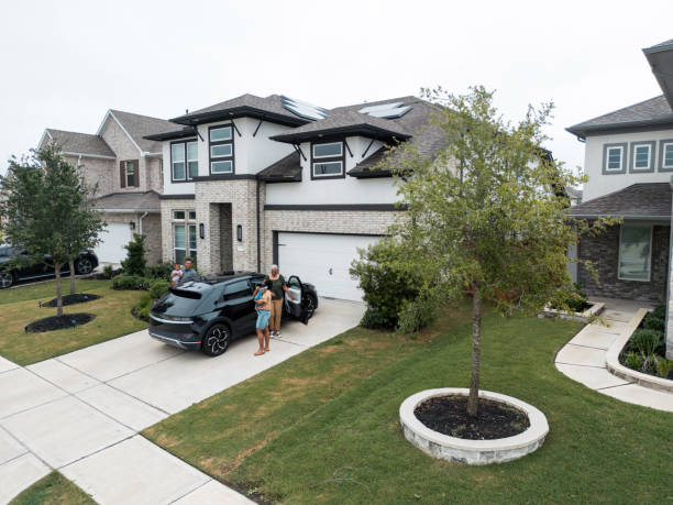 istock Diverse Family Enjoying Time Near Energy-Efficient Home with EV 2156804598