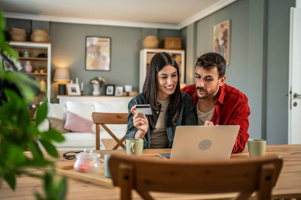 istock Young couple in love using laptop for online shopping 2156804606