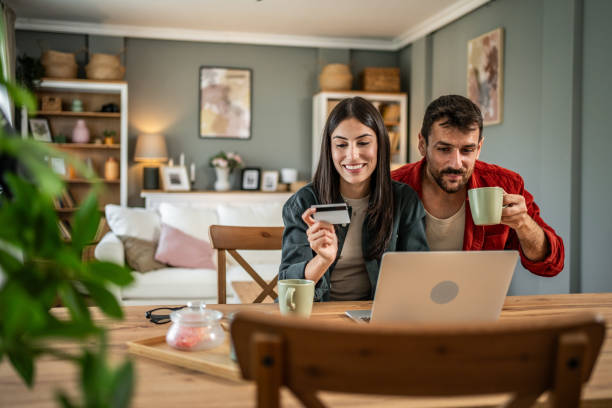 istock Young couple in love using laptop for online shopping 2156804821