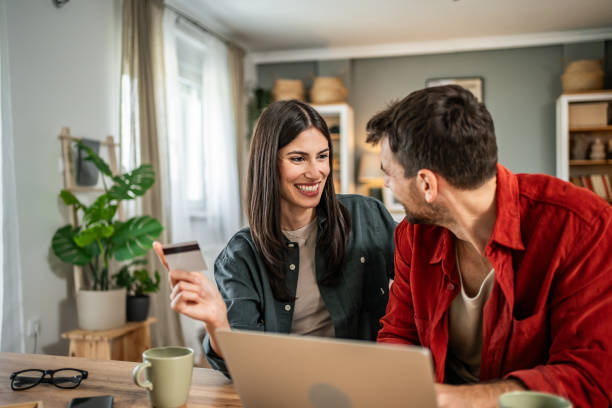 istock Young couple in love using laptop for online shopping 2156804825