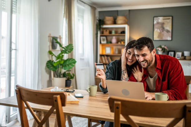 istock Young couple in love using laptop for online shopping 2156804972