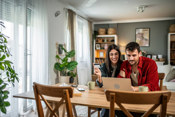 istock Young couple in love using laptop for online shopping 2156804973