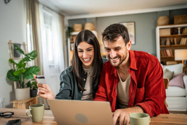 Young couple in love using laptop for online shopping