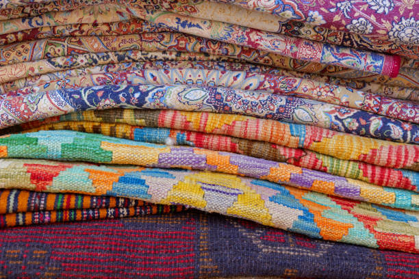 istock Vintage oriental rugs stacked. Authentic old background 2156805635