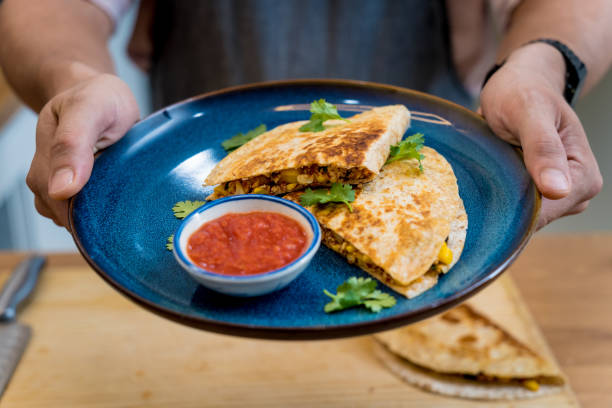 istock Chef at the kitchen preparing quesadillas with tofu and sweet corn 2156805785