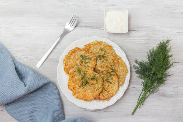 istock Potato pancakes with sour cream and dill. 2156806899