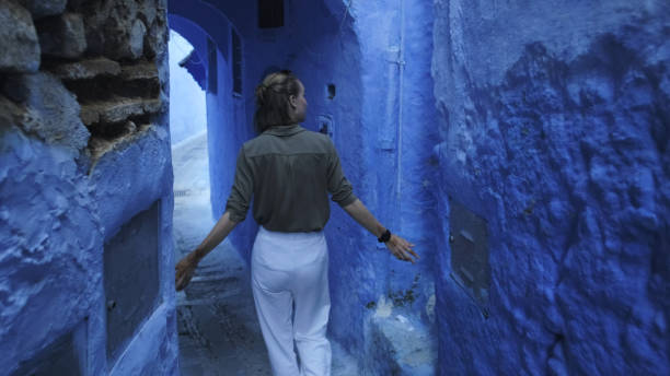 istock Young woman explores colourful, narrow streets 2156807702