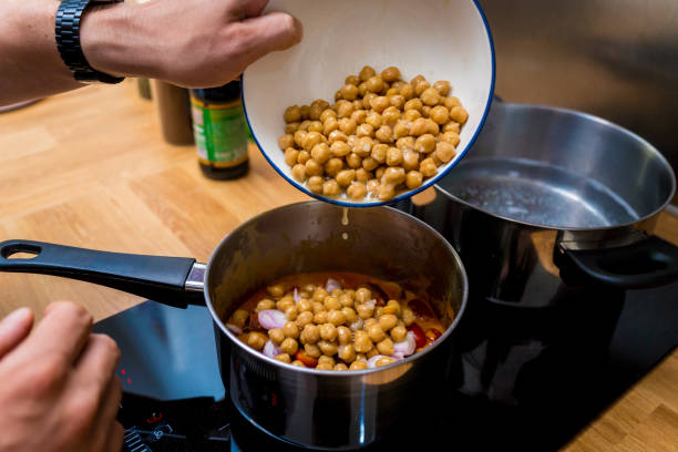 Chef at the kitchen preparing massaman curry with sweet potato and many spices